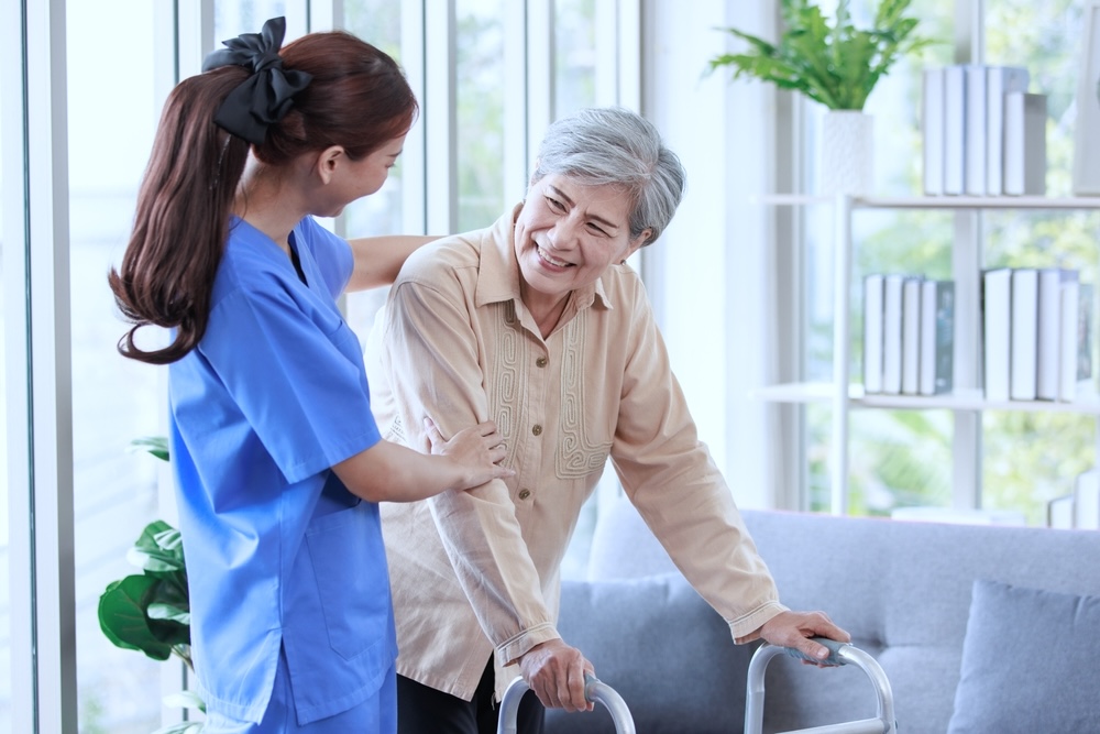 Adult female with walker undergoing elderly rehabilitation therapy